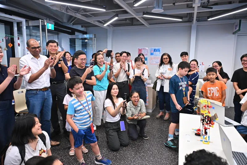 Families cheering a robot across the finish line