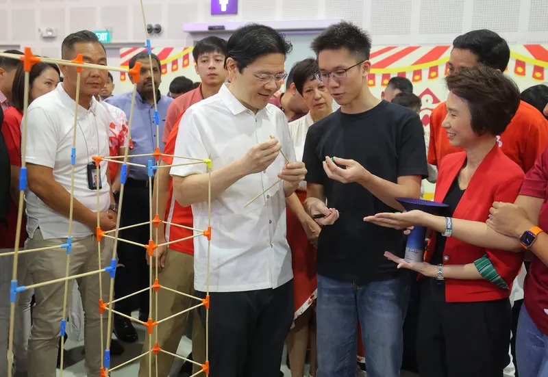 Prime Minister Lawrence Wong trying Stick ’Em connectors