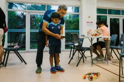 A father and son drive their buggy outdoors