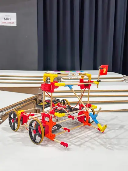 A red rail buggy on the wooden floor