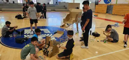 Building on mats across the gym floor