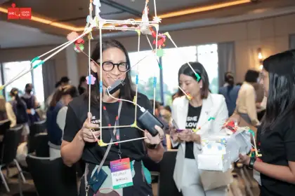 Grinning through a chopstick frame at Girls Love Tech