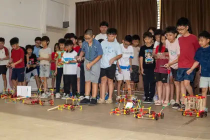 Holding up their finished robots together