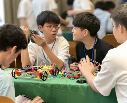 Kids at a table of cars