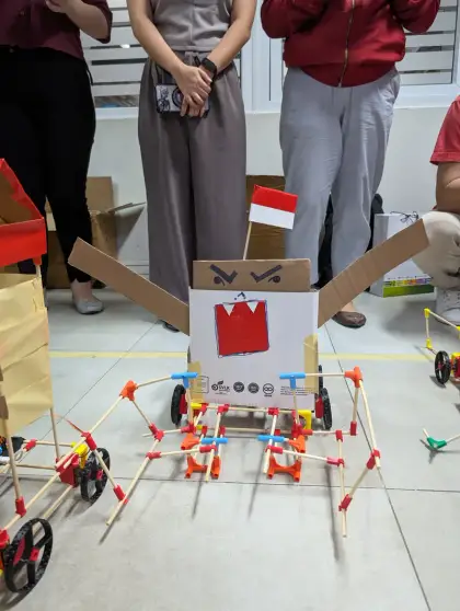 A cardboard robot flying the Indonesian flag