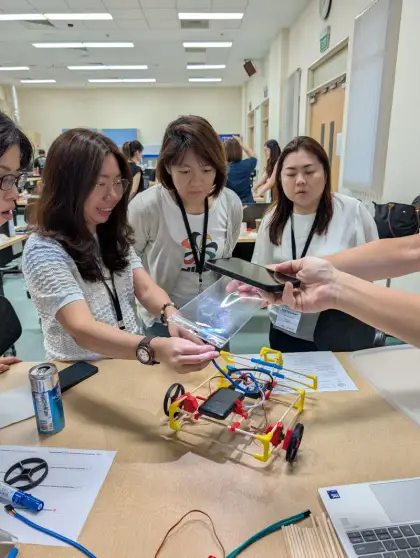 Teachers wiring up a car