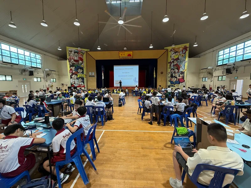 Rulang Primary School’s hall full of teams building at Robotics for a Better World 2025