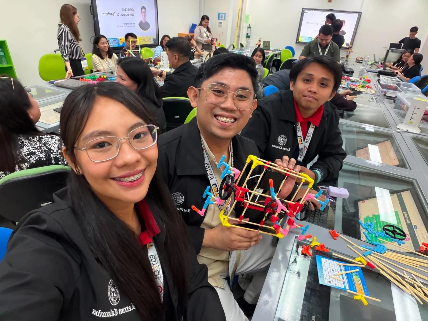 Teachers at a Stick ’Em workshop in the Philippines holding up a chopstick build